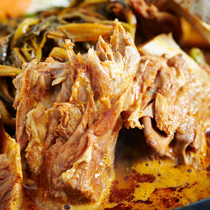 Close-up of braised meat with vegetables in a rich sauce