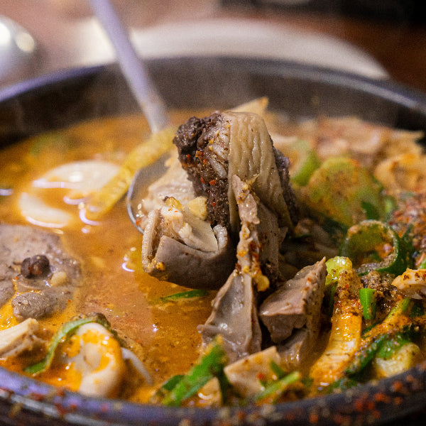 Hot pot dish with various ingredients in a pot on a table